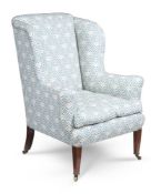 A MAHOGANY AND UPHOLSTERED WING ARMCHAIR, BY HOWARD & SONS, LATE 19TH CENTURY