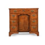 A GEORGE II BURR AND FIGURED WALNUT KNEEHOLE DESK, CIRCA 1735