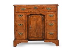 A GEORGE II BURR AND FIGURED WALNUT KNEEHOLE DESK, CIRCA 1735