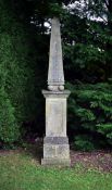 A STONE COMPOSITION OBELISK ON PLINTH, LATE 20TH CENTURY