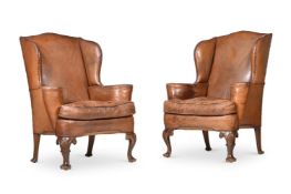 A PAIR OF MAHOGANY AND LEATHER UPHOLSTERED WING ARMCHAIRS, IN GEORGE II STYLE, EARLY 20TH CENTURY