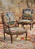A PAIR OF RÉGENCE CARVED WALNUT AND NEEDLEWORK UPHOLSTERED ARMCHAIRS, CIRCA 1720