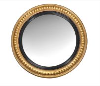 A REGENCY GILTWOOD CONVEX WALL MIRROR OF VERY LARGE SIZE