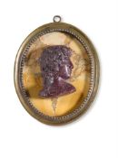 A GRAND TOUR PORPHYRY PORTRAIT CAMEO, PROBABLY ANTINOUS, IN THE LATE 18TH CENTURY MANNER