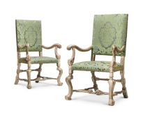 A PAIR OF CARVED WOOD, PAINTED AND SILVERED ARMCHAIRS, ONE CIRCA 1700