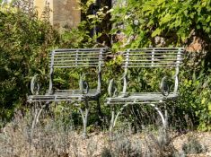 A NEAR PAIR OF FRENCH WROUGHT, CAST AND BENT IRON GARDEN ARMCHAIRS, BY THE SAINT SAUVEUR FACTORY