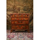 A GEORGE I WALNUT CROSS AND FEATHER-BANDED BACHELOR'S CHEST OF DRAWERS, CIRCA 1720