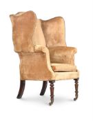A GEORGE III MAHOGANY AND UPHOLSTERED WING ARMCHAIR, CIRCA 1800
