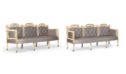 A PAIR OF GEORGE III CREAM PAINTED, POLYCHROME DECORATED, PARCEL GILT AND BUTTON UPHOLSTERED SETTEES