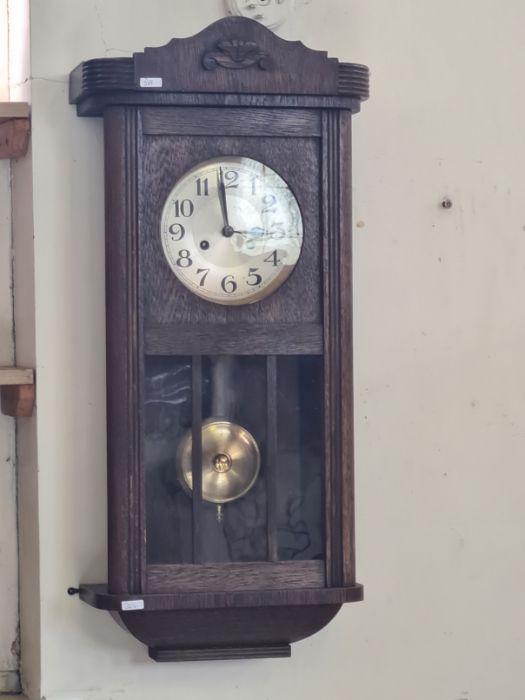 1930's oak chiming wall clock with pendulum window.