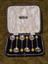 A cased set of coffee bean spoons