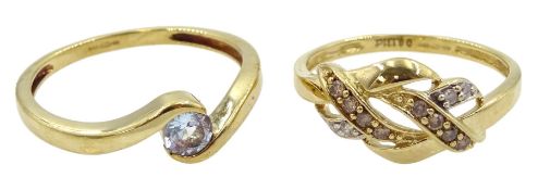 Gold single stone aquamarine ring and a gold champagne and white diamond crossover ring