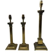 Pair of brass Corinthian column table lamps on square bases together with another similar lamp all w