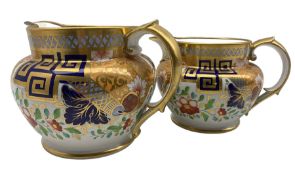 Pair of early 19th century graduated water jugs decorated with bands of trailing flowers with blue a