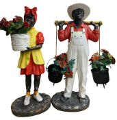 Pair of fibre glass figures in the form of a boy and girl wearing provincial costume both with hangi