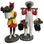 Pair of fibre glass figures in the form of a boy and girl wearing provincial costume both with hangi