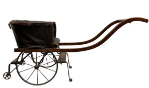 Victorian child's two wheeled dog cart with buttoned leather tub shape seat