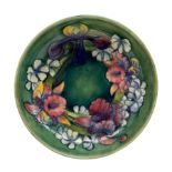 Walter Moorcroft Orchid pattern bowl on a green wash ground