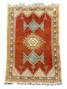 Ground rug with orange field and one central medallion