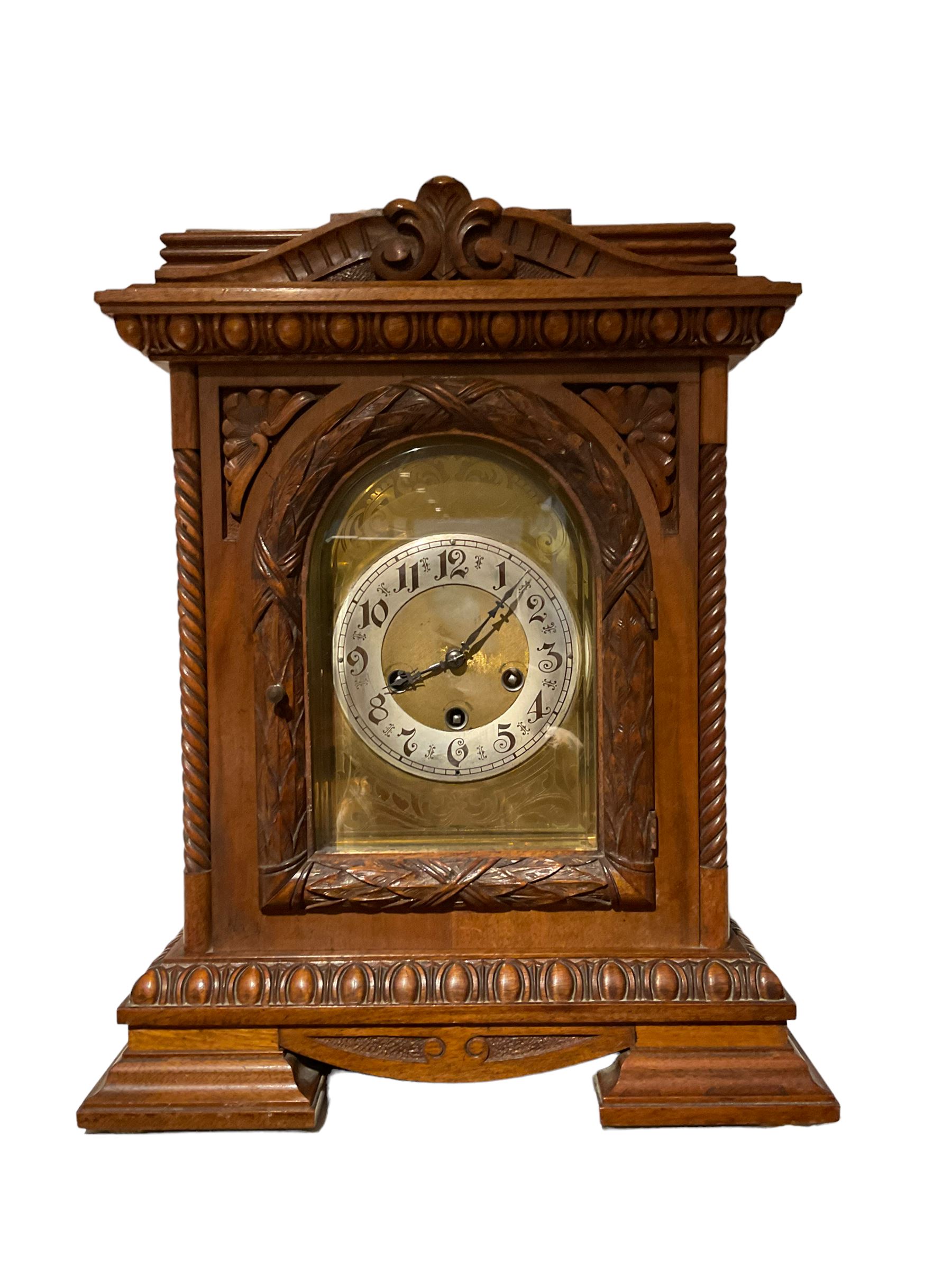 German - early 20th century 8-day chiming mantle clock in a carved oak case