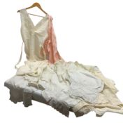 Quantity of early 20th century vintage undergarments to include white silk night gown with waist tie