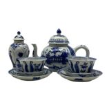 Pair of Chinese blue and white Kangxi tea bowls and saucers decorated with seated and standing figur