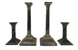 Two pairs of Victorian silver-plated Corinthian column candlesticks