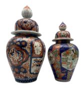 Japanese Imari baluster form vase with cover decorated in the typical palette together with another