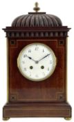 French - 19th- century 8-day Mahogany mantle clock with a carved pediment surmounted by a turned bra