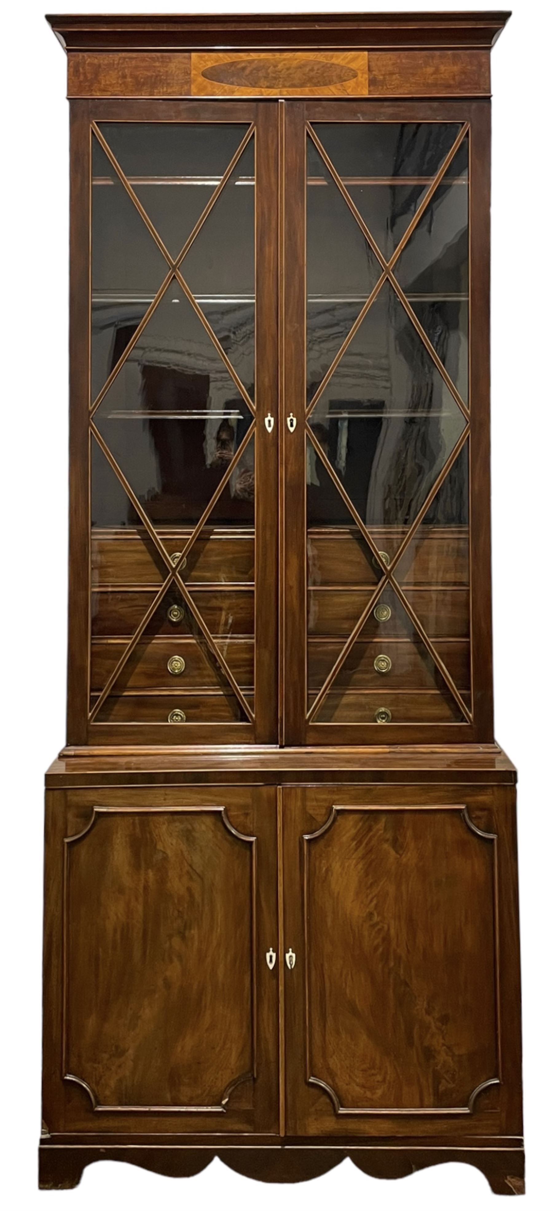 Tall George III mahogany bookcase on cupboard