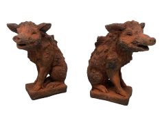 Pair of terracotta finish composite stone garden figures in the form of wild boars