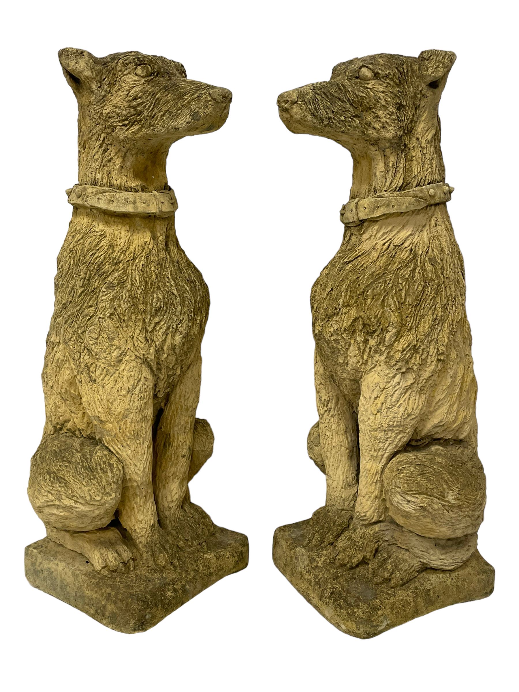 Pair of composite stone garden ornaments in the form of seated lurchers
