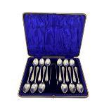 Set of twelve silver tea spoons and tongs with bright cut stems Sheffield 1905 Maker C W Fletcher &