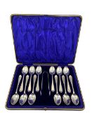 Set of twelve silver tea spoons and tongs with bright cut stems Sheffield 1905 Maker C W Fletcher &