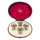 Set of four Edwardian silver three handled tot cups