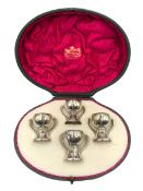 Set of four Edwardian silver three handled tot cups