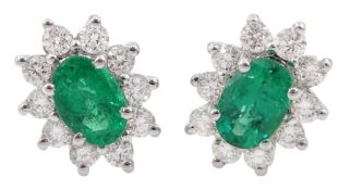 Pair of 18ct white gold oval emerald round brilliant cut diamond stud earrings