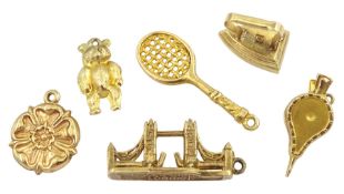 Six 9ct gold pendant/charms including Tower Bridge London