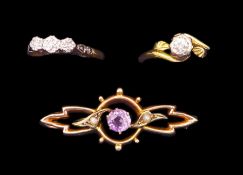 Gold single stone diamond ring and a three stone diamond ring