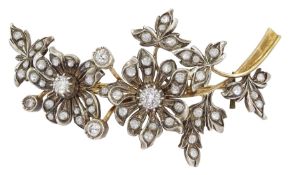 Early 20th century gold and silver white sapphire and paste stone set flower spray brooch