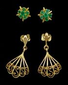 Pair of gold pendant stud earrings and a pair of gold emerald cluster stud earrings