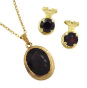 Gold oval smoky quartz pendant necklace and a pair of gold garnet clip on earrings