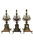 Pair of Continental rococo style gilt metal ornate table lamps with foliate decoration featuring pai