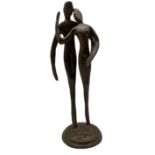 Brutalist bronze sculpture of lovers embracing