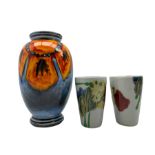 Poole pottery poppy pattern vase of ovoid form and two small Dartington vases designed by Janice Tch