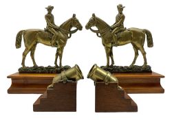 Pair of "Dr Jim" brass doorstops