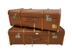 Two vintage wood bound travelling trunks in brick red colour