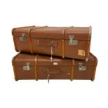 Two vintage wood bound travelling trunks in brick red colour