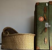 Early 20th century travel trunk covered in green fabric; and wicker moses basket