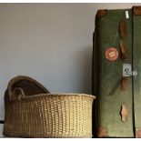 Early 20th century travel trunk covered in green fabric; and wicker moses basket